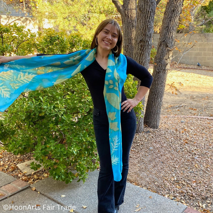 Handwoven silk scarf with unique eco-printed patterns in turquoise hues