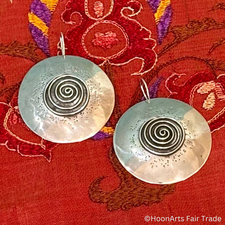 Sterling silver disc earrings with intricate spiral pattern