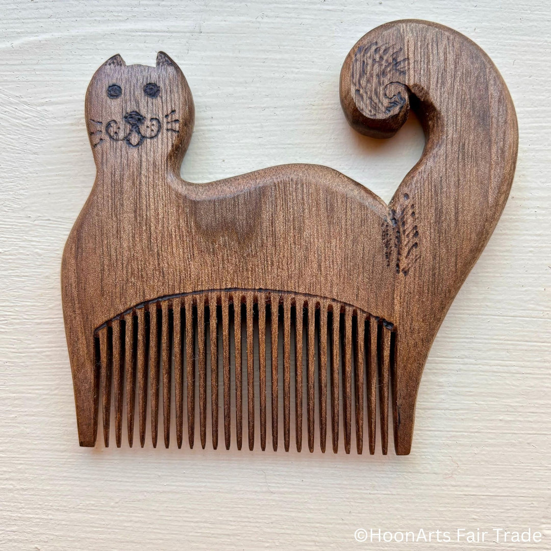 tiny cat comb made from walnut wood handcarved by master Sodiq Zaripov