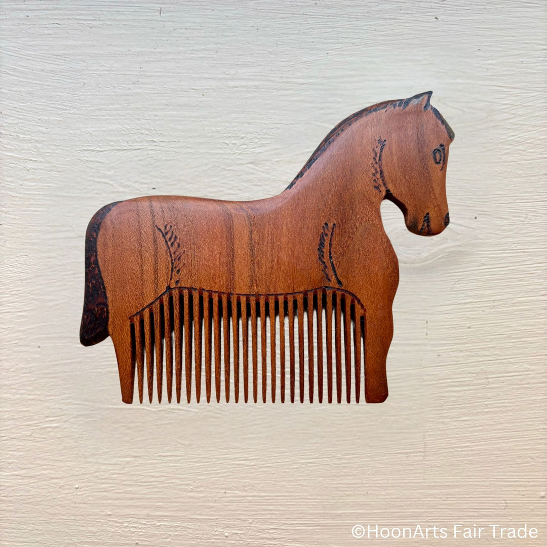 tiny horse comb made out of apricot wood handcarved by master Sodiq of Tajikistan