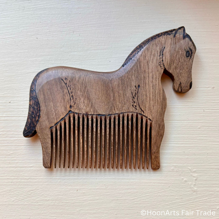 tiny horse comb made out of walnut