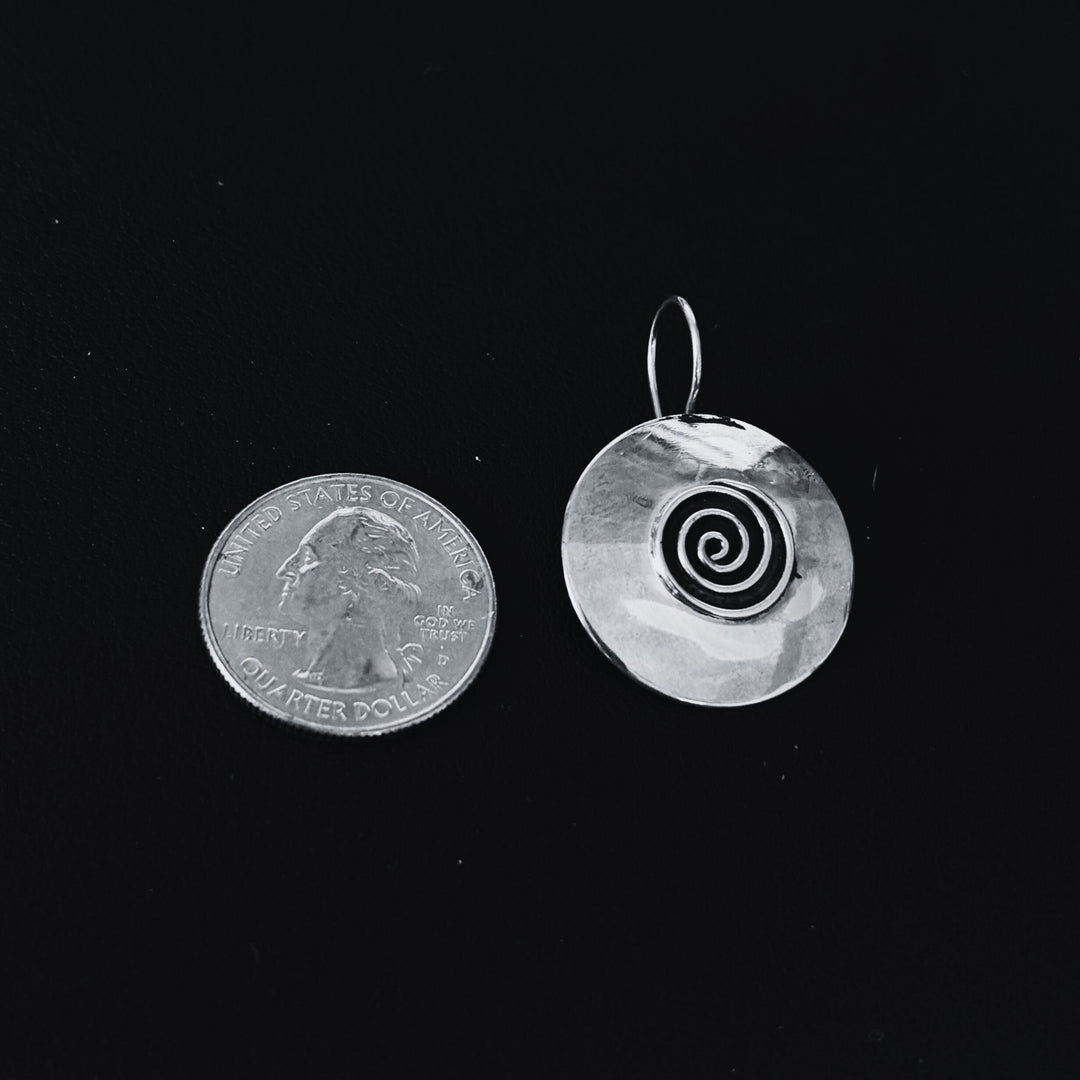 Silver Disc Earring ("Zamira") with Small Eternity Spiral in the Middle, alongside US quarter which is slightly smaller in size