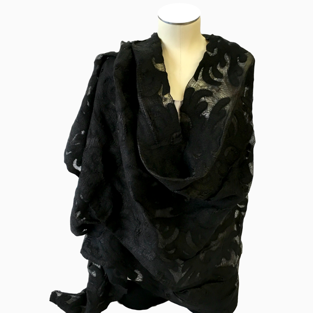 Sheer black felted silk shawl, with traditional Kyrgyz eagle pattern, displayed on mannequin torso
