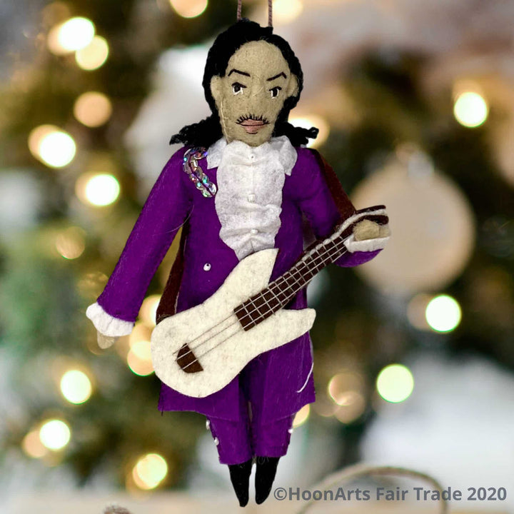 Handmade Felt Christmas Ornament-Musical Artist Prince, dressed in purple with sequins and guitar, hanging against a background of blurred sparkling Christmas twinkle lights
