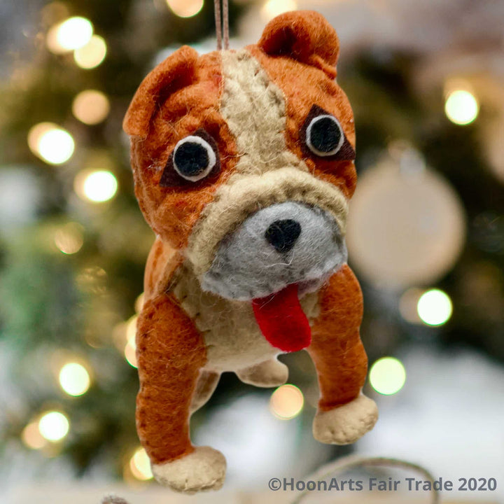 Felt bulldog Christmas ornament, hanging against a backgound of Christmas twinkle lights