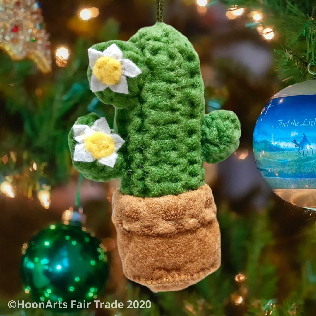 Handmade felt Christmas ornament from Krygyzstan, Saguaro cactus, hanging from a brightly decorated Christmas tree