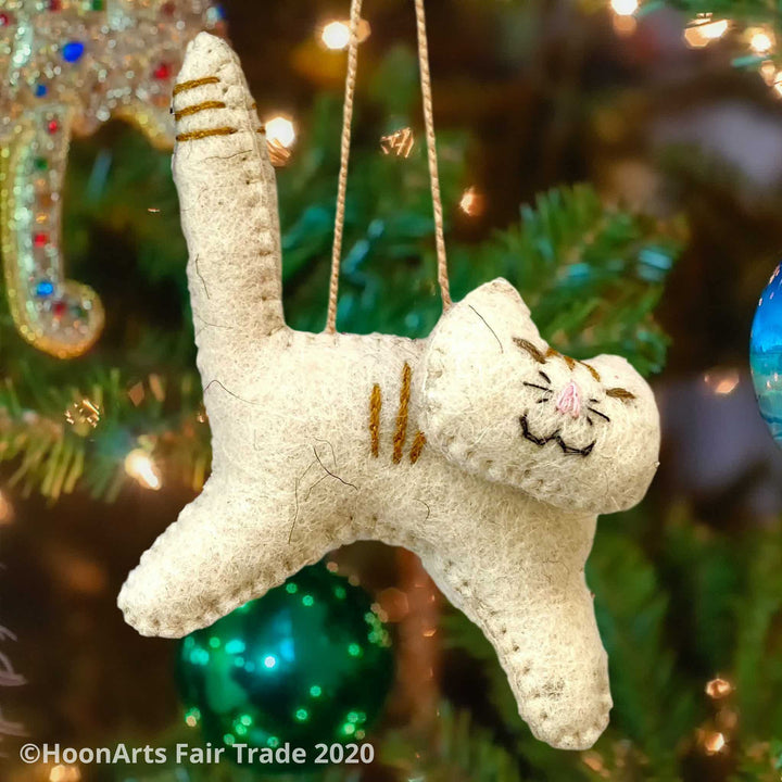 Adorable Smiling White Felt Cat Christmas Ornament-Handmade  in Kyrgyzstan, against Christmas tree background