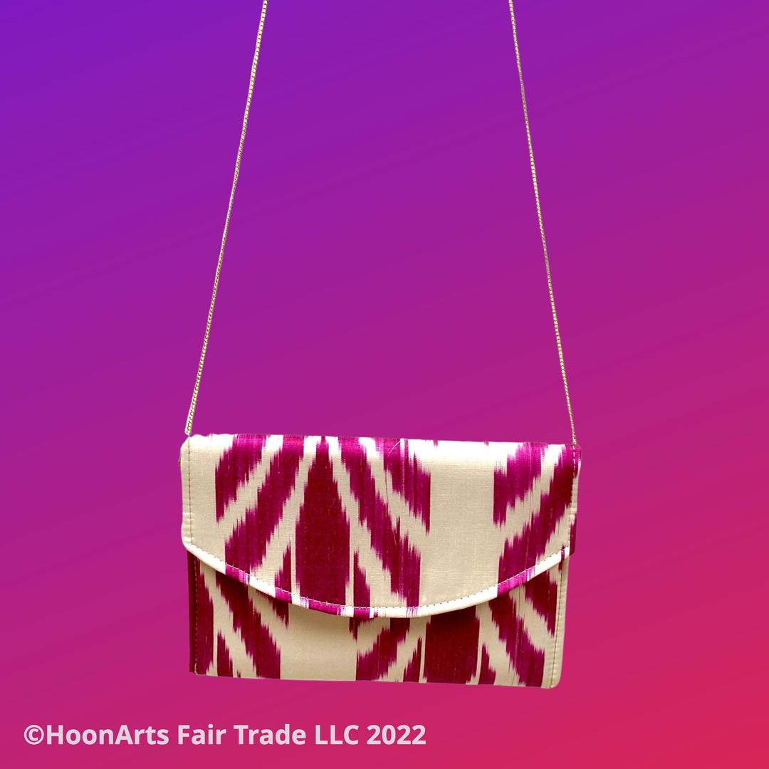 Rectangular clutch bag in white and magenta silk ikat with shoulder chain 