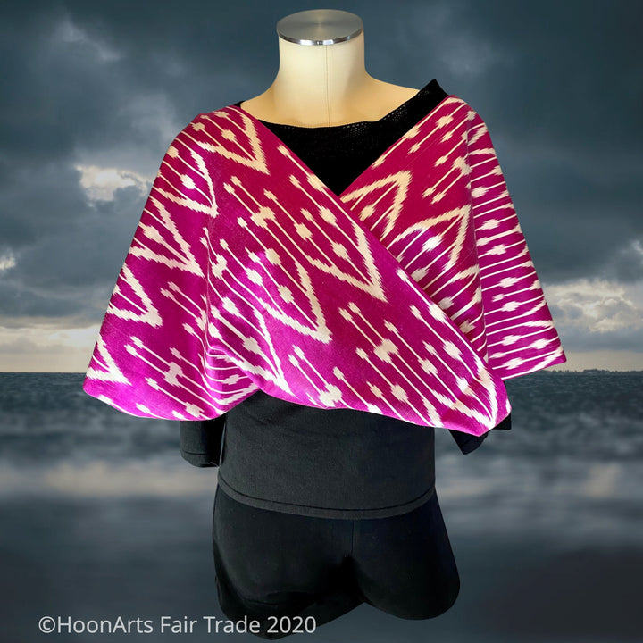 Handwoven Uzbek silk ikat infinity shawl in hot pink and white traditional pattern, draped on mannequin | HoonArts
