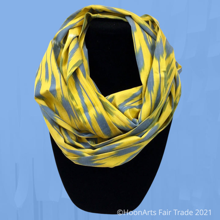 Uzbek Silk Infinity Scarf-Grey Blue Tulips on Bright Yellow, Shown on Necklace Stand