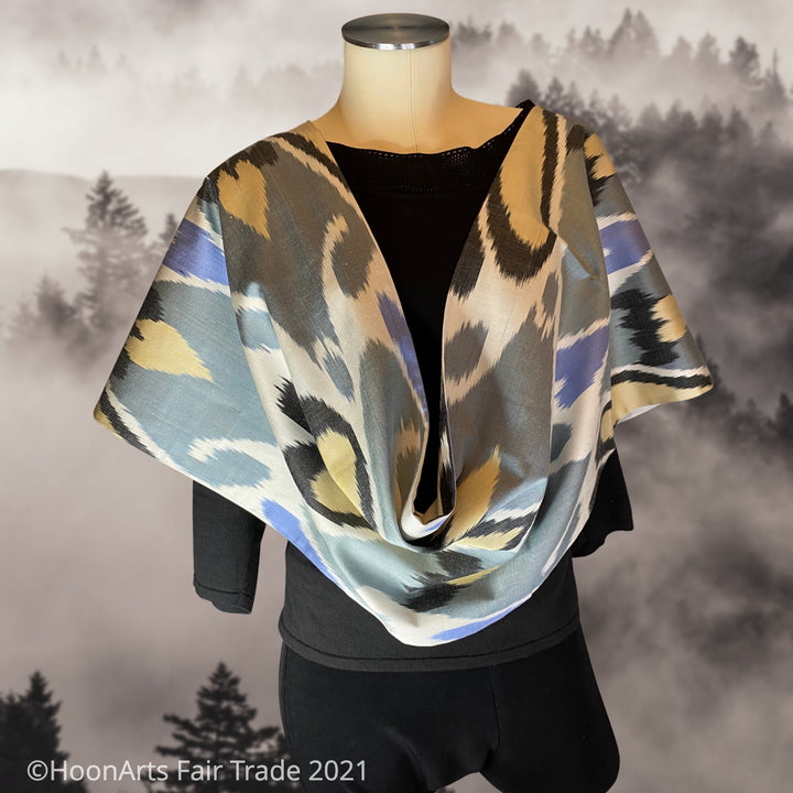Elegant handwoven silk ikat infinity shawl, in traditional Uzbek pattern, with grey, white, black, blue & beige, draped on mannequin  | HoonArts