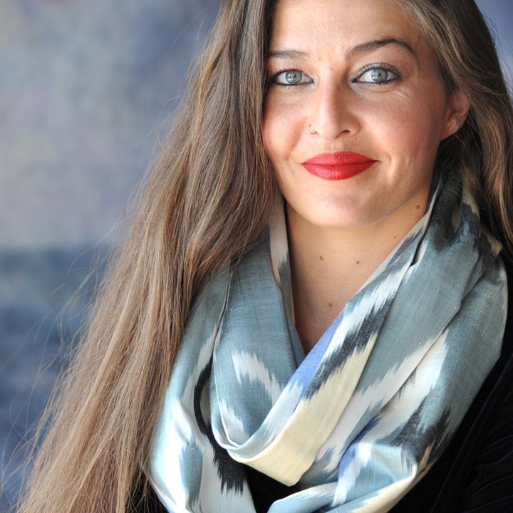 Handwoven Uzbek silk infinity scarf, double-wrapped around the neck of Caucasian woman with long brown hair and striking green eyes | HoonArts