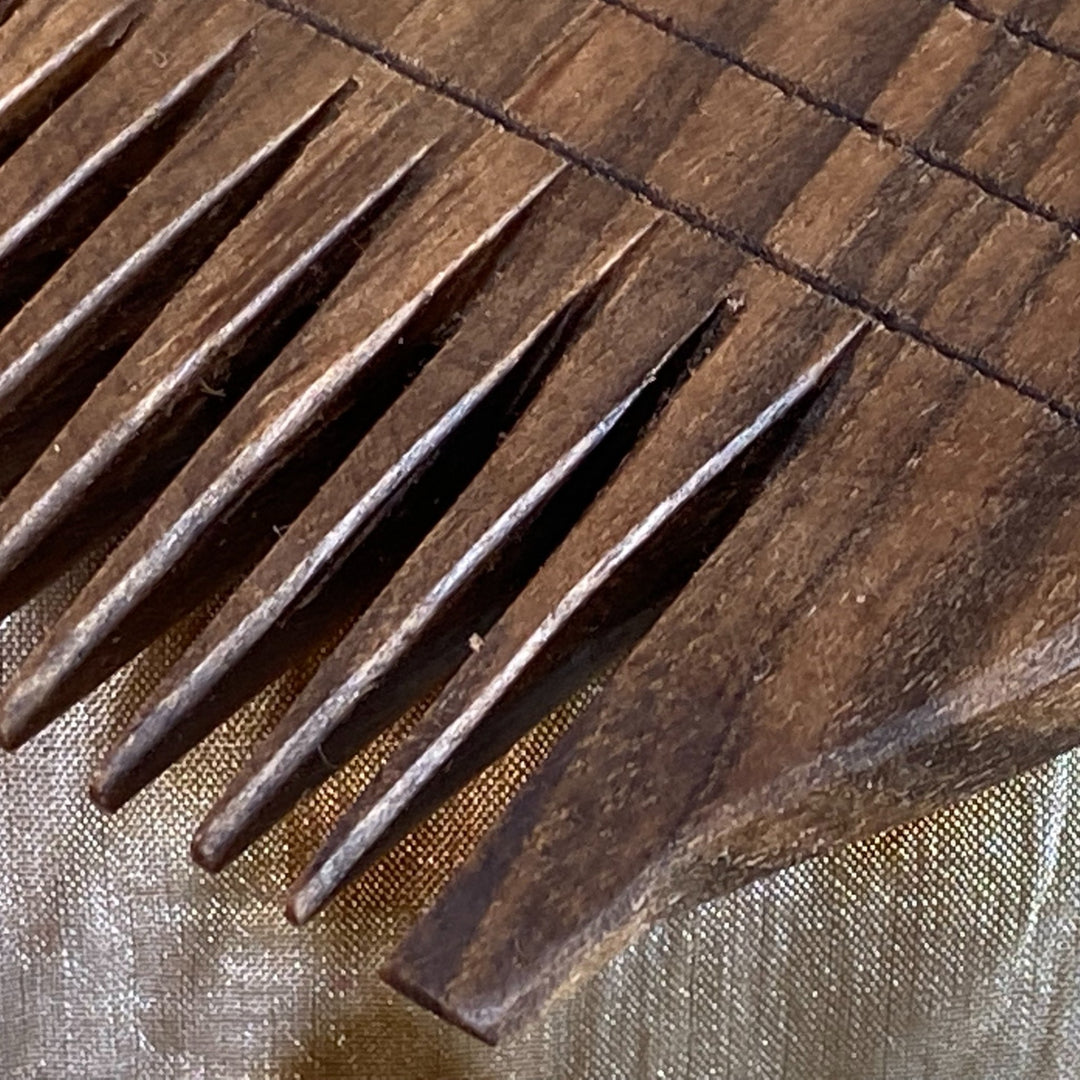 Closeup of hand carved teeth of Ancient Egyptian Double-Sided Comb
