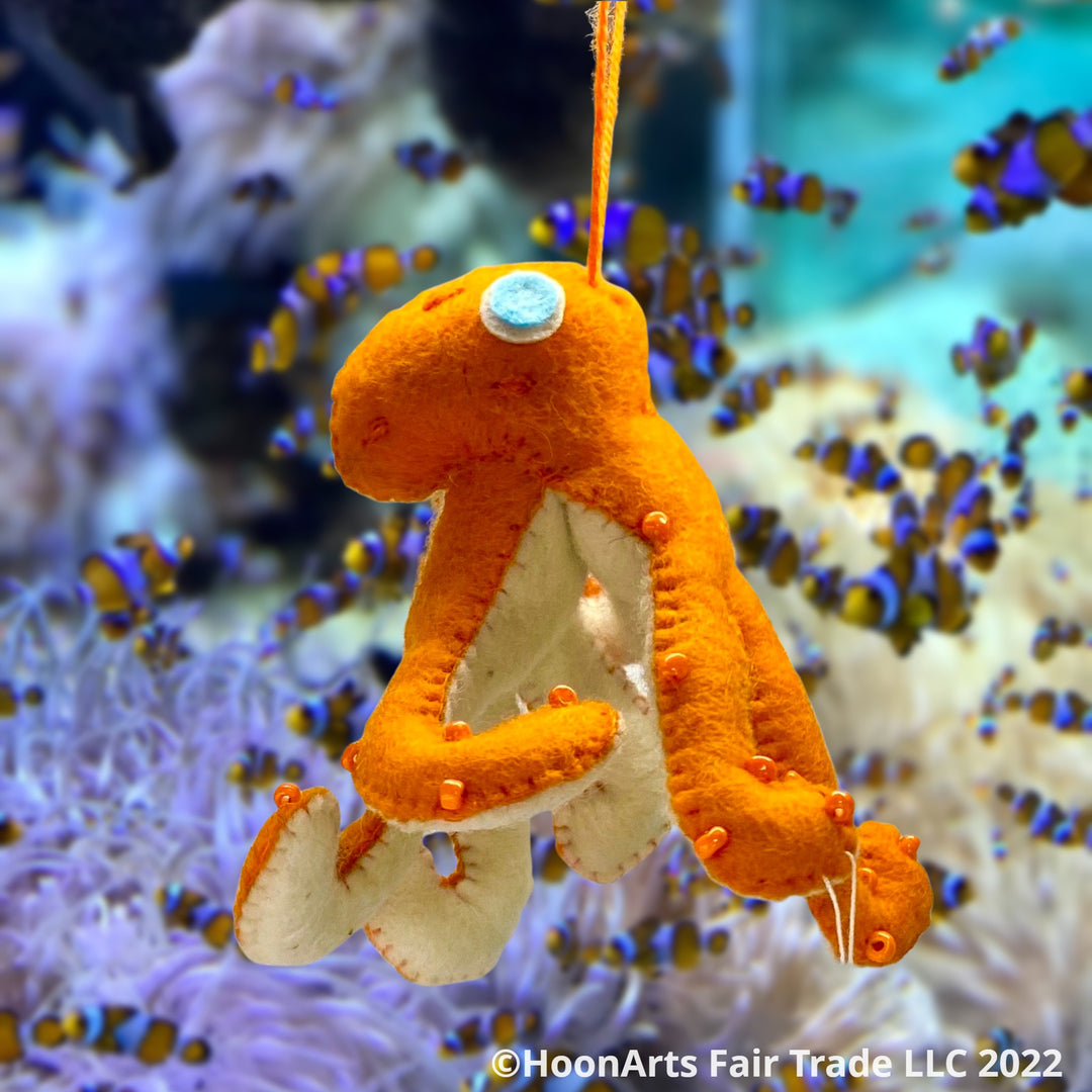 Handmade Felt Ornament-Orange Octopus, with white underside, with orange iridescent beads dotting the orange upper side and bright eyes swimming with fishes