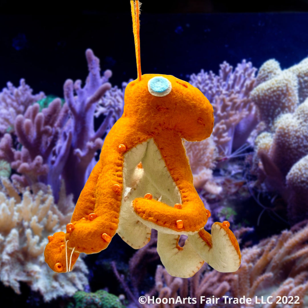 Handmade Felt Ornament-Orange Octopus, with white underside, with orange iridescent beads dotting the orange upper side and bright eyes