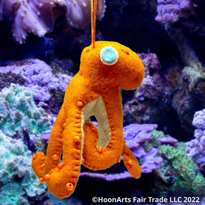 Handmade Felt Ornament-Orange Octopus, with white underside, with orange iridescent beads dotting the orange upper side and bright eyes swimming in the ocean