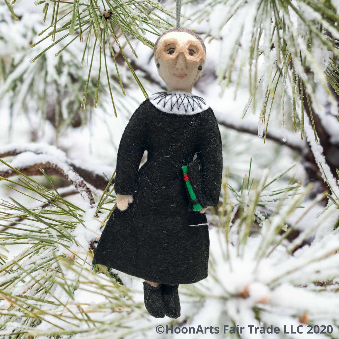 Ruth Bader Ginsburg Handmade Felt Ornament, Dressed in Black Judicial Robes with White Color, Wearing Her Signature Large Eyeglasses, Handing from a Snow-Covered Pine Tree