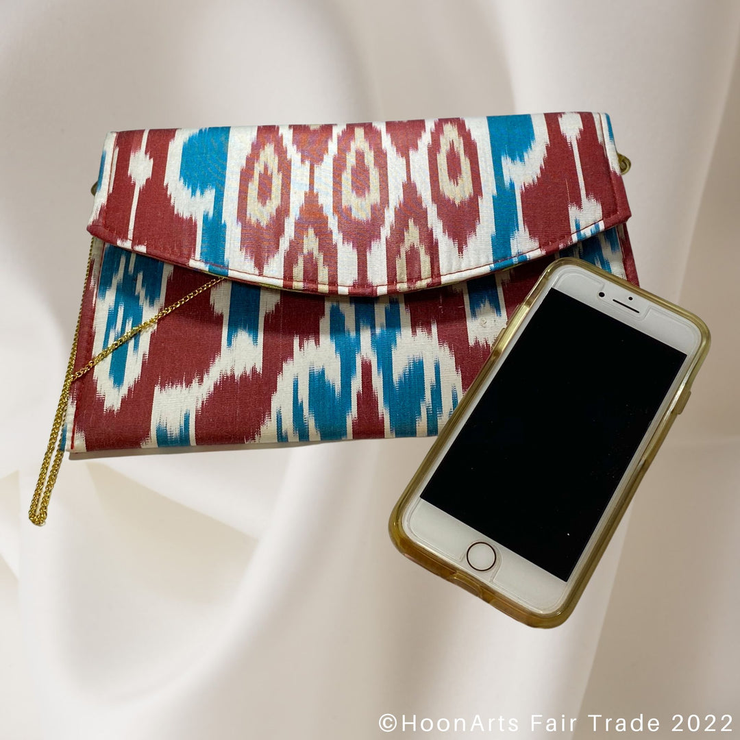 Red, White & Blue Ikat Clutch scale with phone