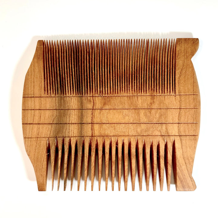 Smal Apricot Wood Reproduction of Ancient Egyptian Two-Sided Comb on White Background