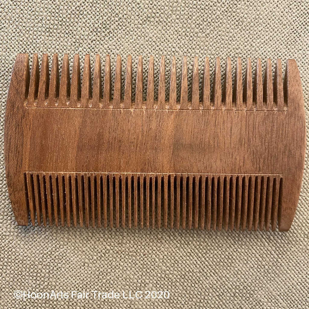 Hand-carved solid walnut beard comb, with large and small teeth on opposite sides of the comb. From Tajikistan.